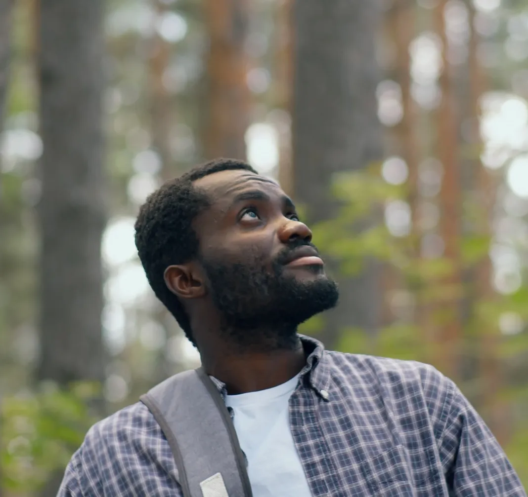 biologist on a field trip, looking to the sky